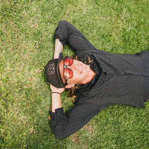 man laying down in grass with sunglasses