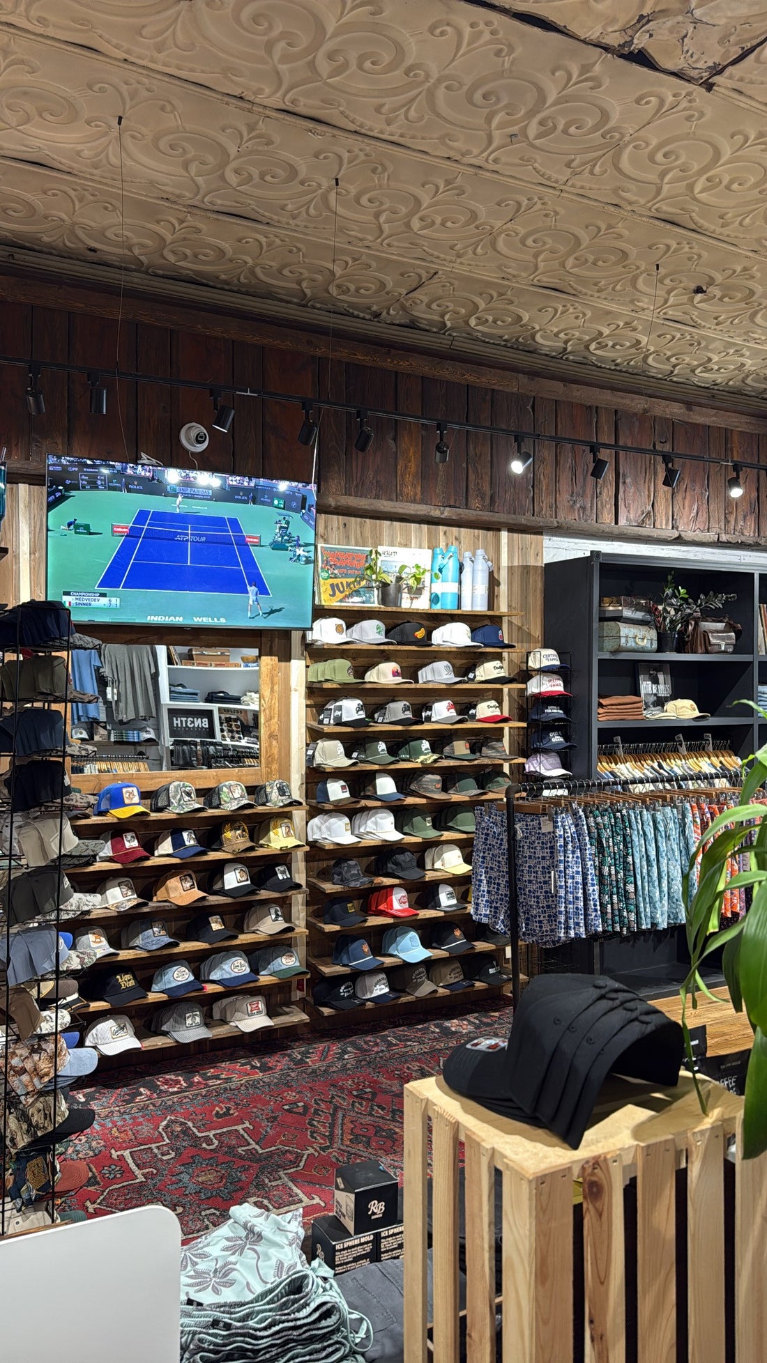 Trucker hat wall and menswear at Rooster Bus Flagstaff