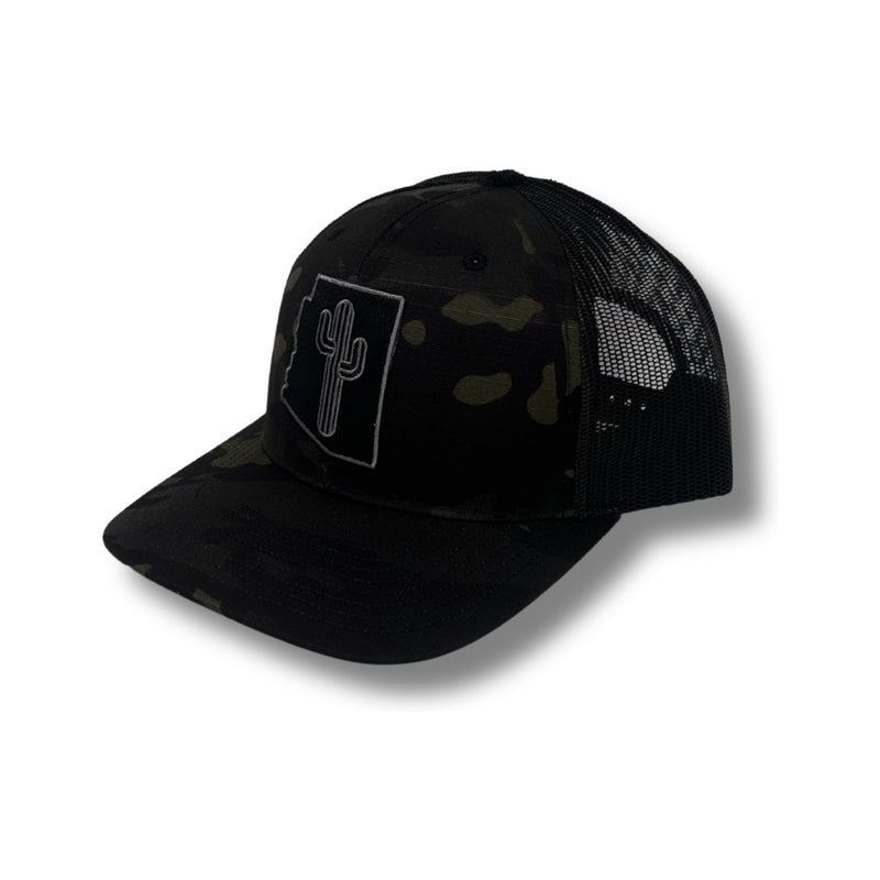 Front view of Local Stated Blacked Out Cactus Stated Hat in Black Camo featuring a tonal embroidered cactus patch on a structured camo crown with a curved brim
