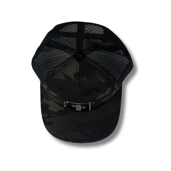 Close-up of tonal cactus patch embroidery and black camo fabric on the Local Stated Cactus Stated Hat