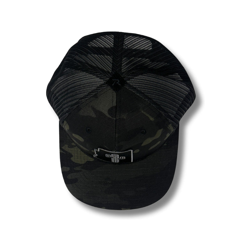 Close-up of tonal cactus patch embroidery and black camo fabric on the Local Stated Cactus Stated Hat