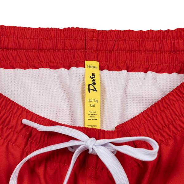 Close-up of waistband stitching, fabric texture, and bright red color on the Duvin Poolside Tanning Swim Short