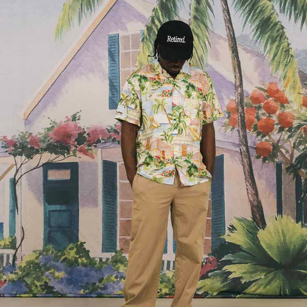 Person wearing the Duvin Retired Hat in Black in a casual, sun-soaked setting with a laid-back vibe