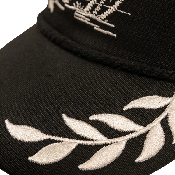 Side profile of black Duvin Tropical Oasis Hat showing curved brim and low-profile crown