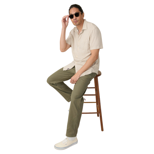 Person wearing the Faherty Hermosa Shirt in Island Sand Fishscale in a relaxed, beachside or warm-weather setting