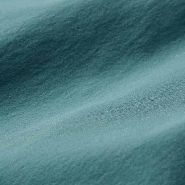 Close-up of the soft, stretchy fabric and drawstring waistband on the Fair Harbor Breaker Short in Seapine