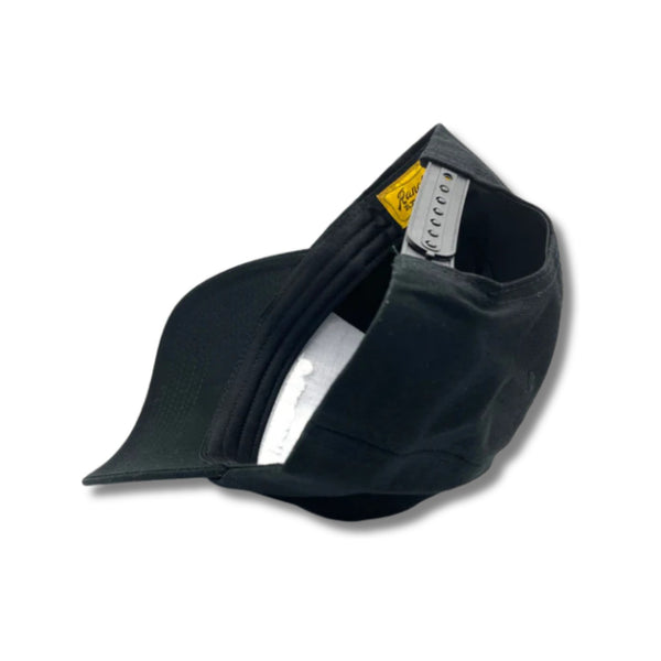 Flat lay of Ranchero Revival Gallop Hat in black showing front horse patch and classic trucker structure