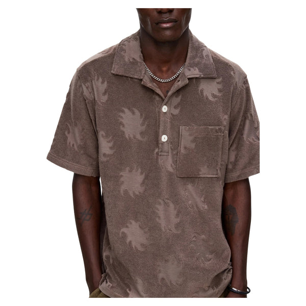 Person wearing the OAS Ember Girona Terry Shirt in a sun-soaked resort or poolside setting