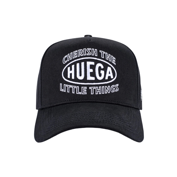 Front view of Huega House Circuit Hat in Black featuring minimalist tonal logo embroidery on a structured crown with a flat brim
