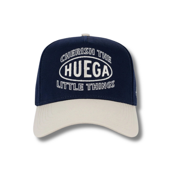 Front view of Huega House Circuit Hat in Natural and Navy featuring tonal Circuit logo embroidery on a structured natural crown with a contrast navy flat brim