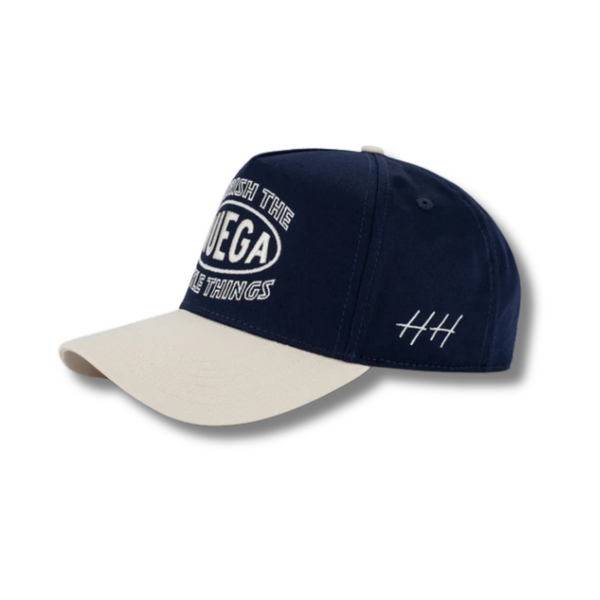 Side view of Huega House Circuit Hat in Natural/Navy showing mid-profile fit, contrast color brim, and minimalist silhouette