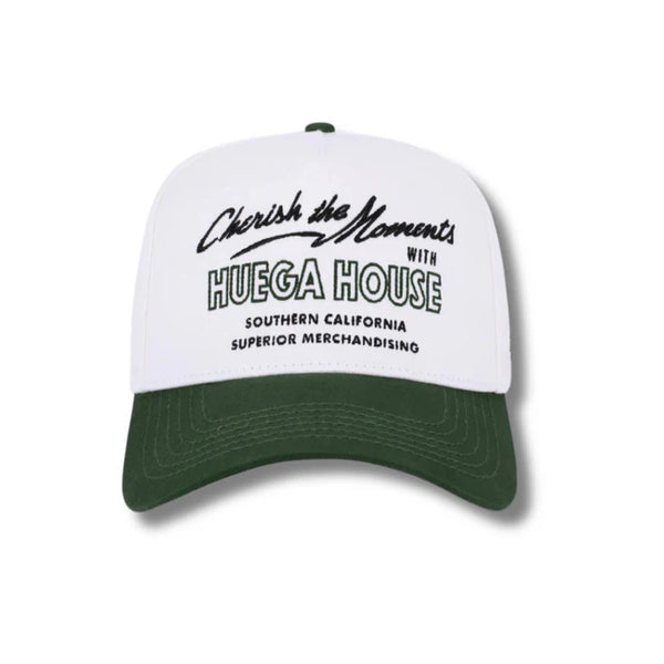 Front view of Huega House Moments Hat in Pine Green and White featuring embroidered “Moments” text on a structured pine green crown with a white curved brim