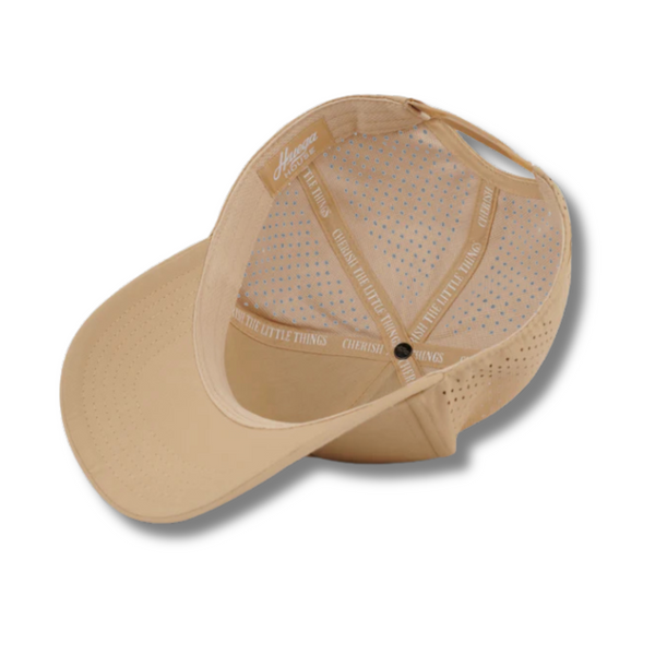 Flat lay of Huega House Performance Hat – Success in Khaki showcasing embroidered front text, structured fit, and quick-dry fabric
