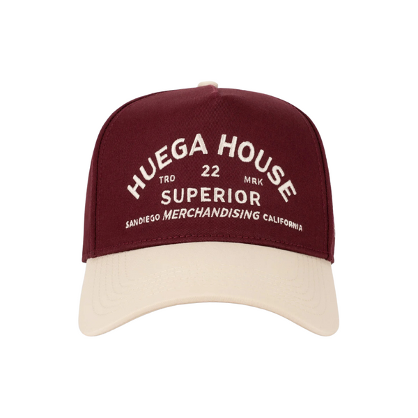 Front view of Huega House Trademark Hat in Natural and Maroon featuring the Huega House logo embroidered on a structured crown with a contrast maroon brim