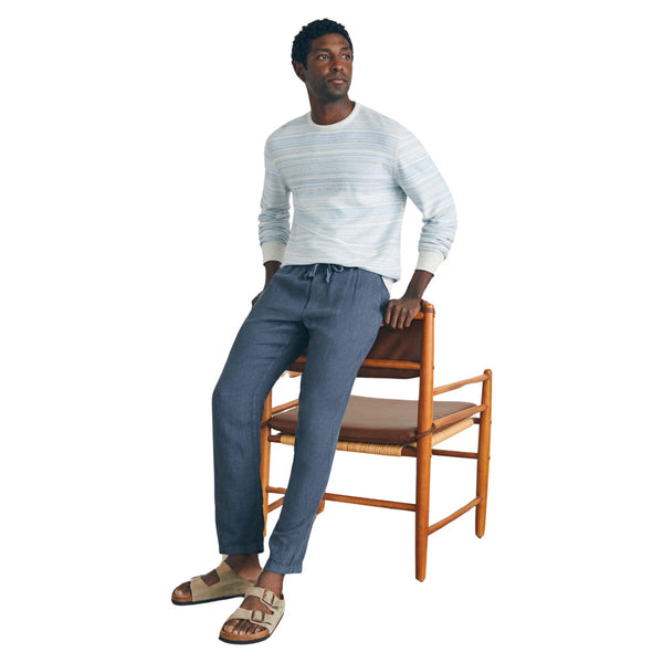 Person wearing the Faherty Linen Drawstring Pant in Look Out Navy in a casual, coastal setting