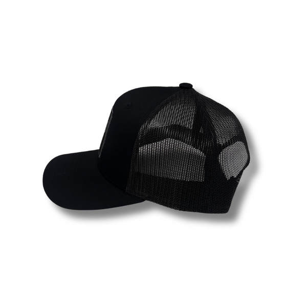 Side view of Local Stated BA Cactus Stated Hat in Black/Black showing subtle stitching, curved brim, and mid-profile fit