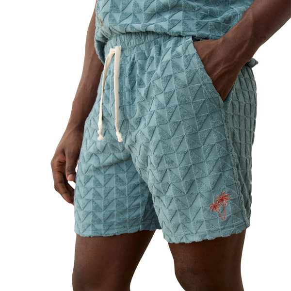 Side view of Marine Layer Towel Terry Short in North Atlantic showing mid-thigh length, side pocket, and vintage-inspired terry texture