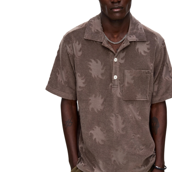 Person wearing the OAS Ember Girona Terry Shirt in a sun-soaked resort or poolside setting