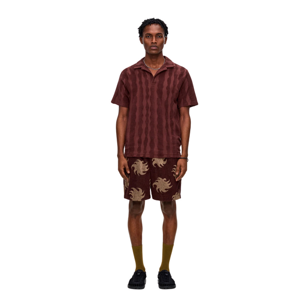 Front view of OAS Polo Terry Shirt in Totem featuring bold totem-inspired pattern, soft terry cloth fabric, and classic polo collar with short button placket