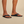 Close-up of strap texture and soft footbed on the OluKai Ulele sandal in black