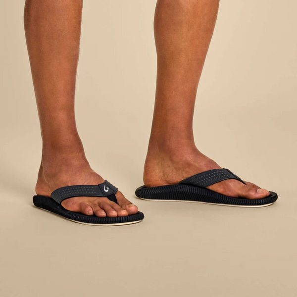 Close-up of strap texture and soft footbed on the OluKai Ulele sandal in black