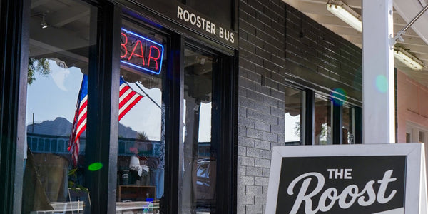 Rooster Bus storefront in Old Town Scottsdale, with The Roost bar sign out front