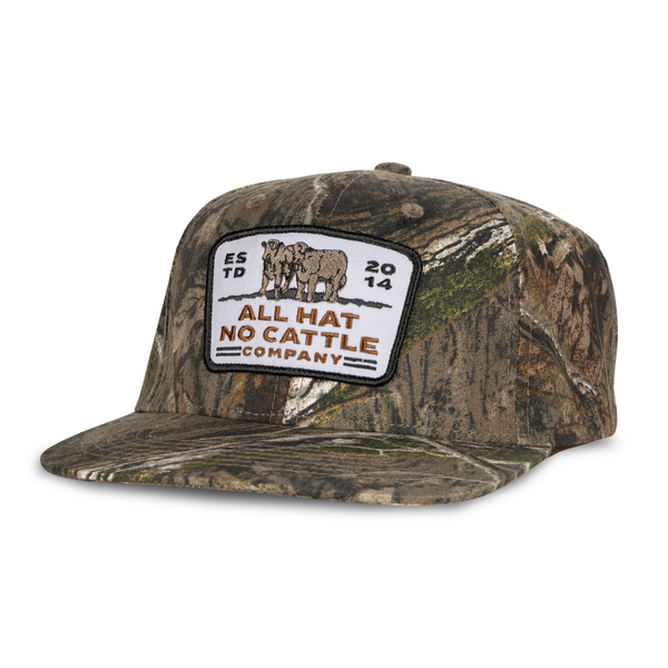 Side view of Sendero All Hat No Cattle Hat in Mossy Oak showing camo print front, breathable mesh back, and classic trucker style