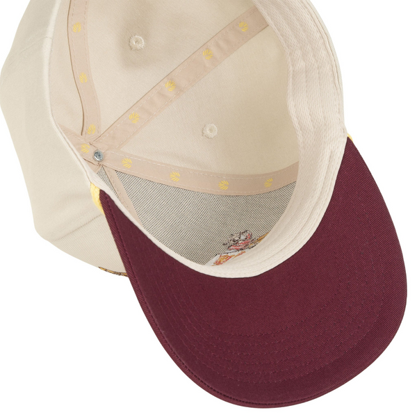 Flat lay of Sendero Buena Suerte Hat in cream and maroon highlighting front patch, curved brim, and two-tone construction