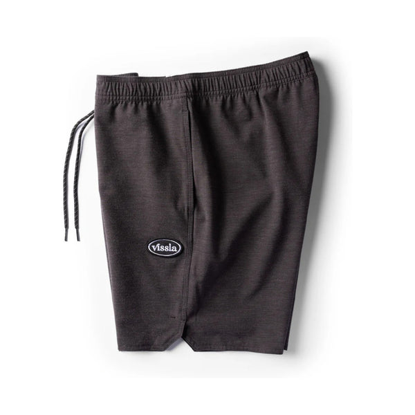 Side view of Vissla Solid Sets Ecolastic Boardshort in Black showing side pocket, relaxed fit, and sustainable fabric blend