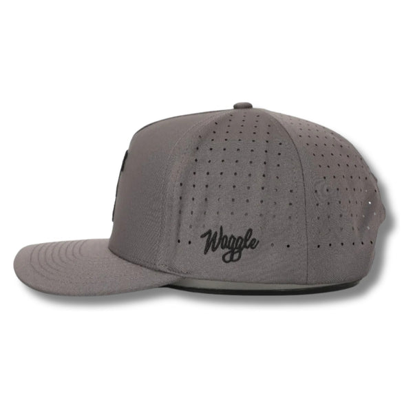 Side view of Waggle Sasquatch Hat in Grey showing curved brim, mid-profile fit, and perforated mesh panels for breathability