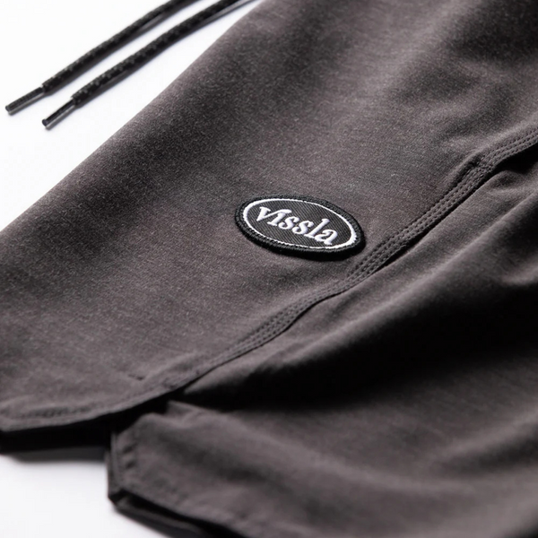 Close-up of waistband, stitching, and sustainable stretch fabric on the Vissla Solid Sets Ecolastic Boardshort in Black