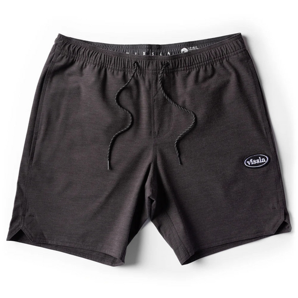 Flat lay of Vissla Solid Sets Ecolastic Boardshort in Black showcasing the elastic waistband, drawstring, and soft eco-conscious fabric