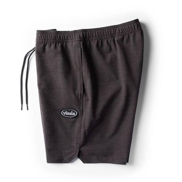 Side view of Vissla Solid Sets Ecolastic Boardshort in Black showing side pocket, relaxed fit, and sustainable fabric blend