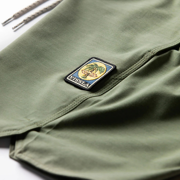 Close-up of surplus green eco-stretch fabric, waistband stitching, and pocket design on the Vissla Ecolastic Boardshort